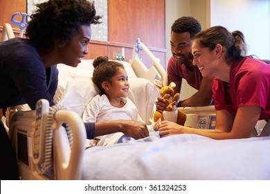 Pediatrician Visiting Parents And Child In Hospital Bed