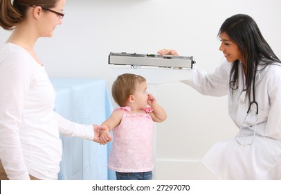 Pediatrician Weighing Young Child