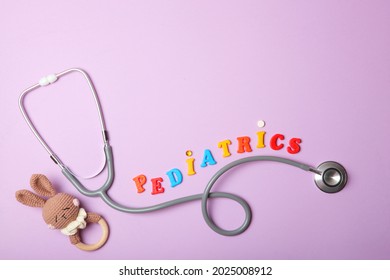  Pediatrics concept. Stethoscope and toy on a light background