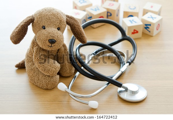 Puppy toy with medical equipment, Pediatric hospital wallpaper mural. 