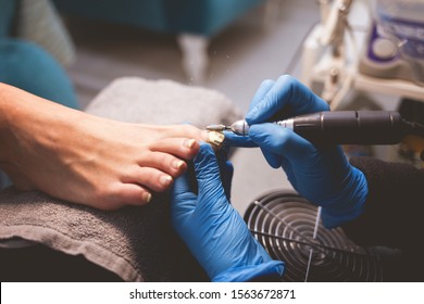 Pedicure master polishes nails before applying varnish - Shutterstock ID 1563672871