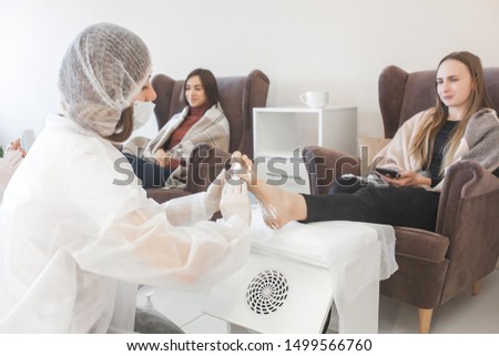 Pedicure in the salon. Master of pedicure doing a procedure for her client. Foot care procedure.