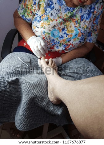 pedicure treatment for an old man at home.