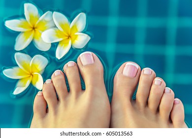 Pedicure Woman's Feet At Spa Near Jasmine Flowers