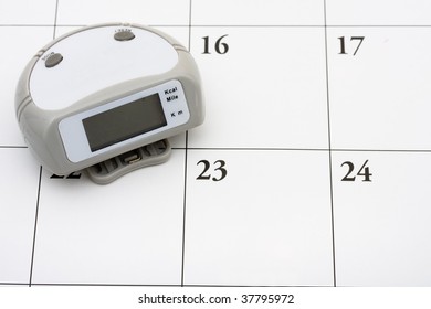 A Pedometer With 10000 Steps On It On Calendar Background, Healthy Lifestyle