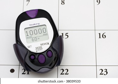 A Pedometer With 10000 Steps On It On Calendar Background, Important Date