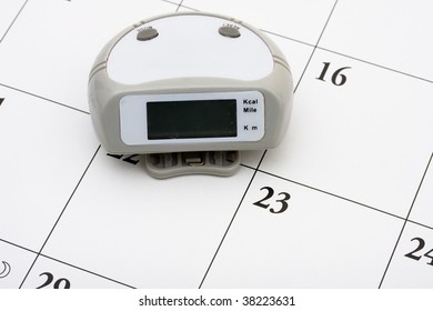 A Pedometer With 10000 Steps On It On Calendar Background, Healthy Lifestyle