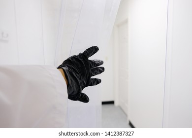 Peek Into Clean Manufacturing Facility With Rubber Gloves And White Walls.