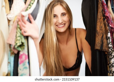 Peek-a-boo. Portrait Of A Beautiful Young Woman Getting Dressed In Her Bedroom At Home.