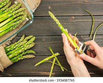 Peel the asparagus. Clean the asparagus. Spring vegetable. Edible sprouts. Raw ingredient. Top view. Flat lay. - Powered by Shutterstock