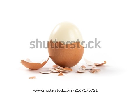 Peeled boiled egg with eggshell isolated on white background