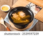 Peeled Chili Chicken Soup with spoon served in bowl isolated on napkin side view of taiwan food