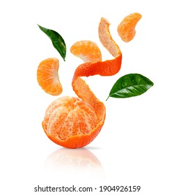 Peeled clementine, sliced mandarine with green leaves flying isolated on white background with clipping path.   