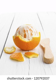 Peeled Orange On White Wooden Background