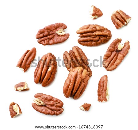 Peeled pecans with broken halves and pieces on a white background. The view from top. 商業照片 © 