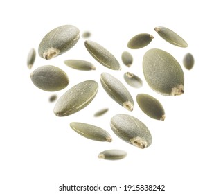 Peeled pumpkin seeds in the shape of a heart on a white background