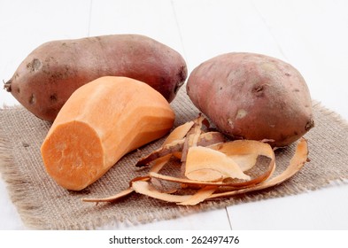 Peeled Sweet Potato And Potato Peel On Jute