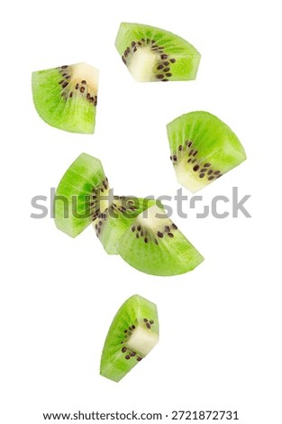 Peeled triangular kiwi slices fall through space. Isolated on white.