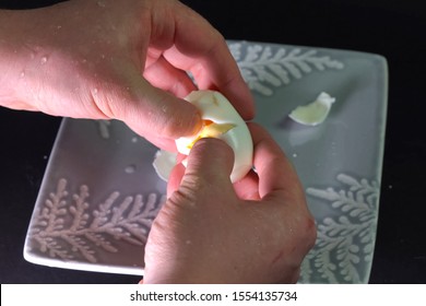 Peeling A Boiled Egg. A Man Is Cleaning An Egg For Breakfast.