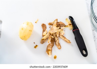 Peeling And Cutting Russet Potatoes To Make Potato Salad.