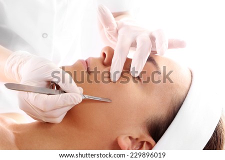Peeling mechanical scalpel face lift.Caucasian woman during surgery using a scalpel