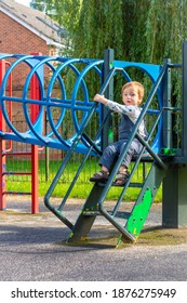 Peeling Paint On This Play Structure With A Little Boy In Dungarees