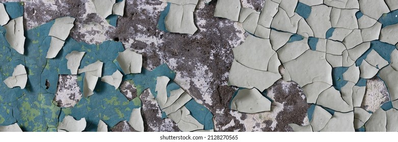 Peeling paint on the wall. Panorama of a concrete wall with old cracked flaking paint. Weathered rough painted surface with patterns of cracks and peeling. Wide panoramic grungy texture for background - Shutterstock ID 2128270565