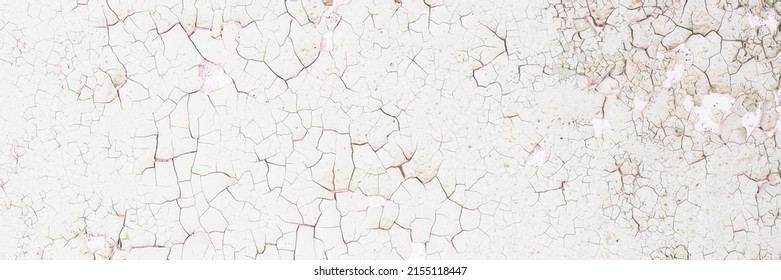 Peeling paint on the wall. Panorama of a concrete wall with old cracked flaking paint. Weathered rough painted surface with patterns of cracks and peeling. Panoramic texture for background and design. - Shutterstock ID 2155118447