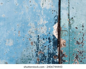 Peeling paint on the wooden wall of an old door  Spread evenly, leaving free space at the top.