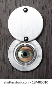 Peephole With Eye Close-up On A Wooden Door