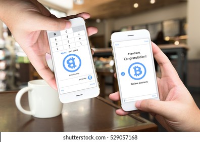 Peer To Peer (P2P) Money Transfer , Electronic Payment , Mobile Payment And E Commerce Concept. Hands Holding Mobile Application For Sent And Receive Money With Coffee Shop Background.