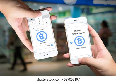 Peer To Peer (P2P) Money Transfer , Electronic Payment , Mobile Payment And E Commerce Concept. Hands Holding Mobile Application For Sent And Receive Money With Retail Store Background.