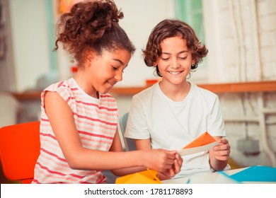 Peer Support. A Girl And A Boy Learning To Make Origami Figures