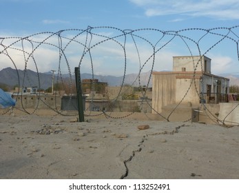 Peering Outside The Wire Of A Military Base In Afghanistan