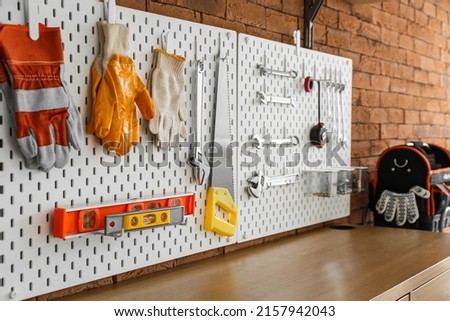 Pegboards with different tools in workshop