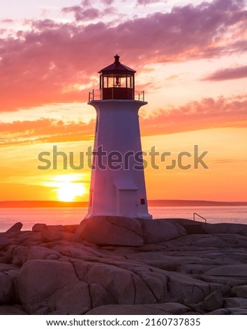 Peggy's Cove Lighthouse during a vibrant sunset. Atlantic Coast, Nova Scotia, Canada. The most visited tourist location in the Atlantic Canada