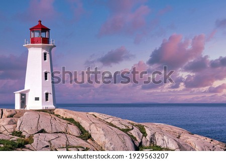 Peggys Cove Lighthouse with pink sunset clouds