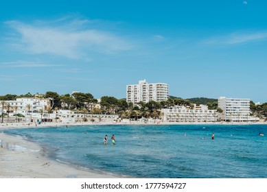 Peguera, Calvià, Mallorca, Spain - June 01 2020: Responsible Tourism Swimming After The Covid On An Almost Empty Beach In The Tourist Front Line