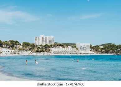 Peguera, Calvià, Mallorca, Spain - June 01 2020: Responsible Tourism Swimming After The Covid On An Almost Empty Beach In The Tourist Front Line