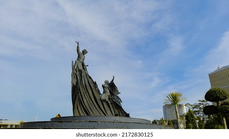 Pekanbaru, Riau, Indonesia - 5 April 2022 : Pekanbaru city landmarks. Pekanbaru's iconic monument, the zapin monument which features two male and female dancers dancing zapin against a bright blue sky