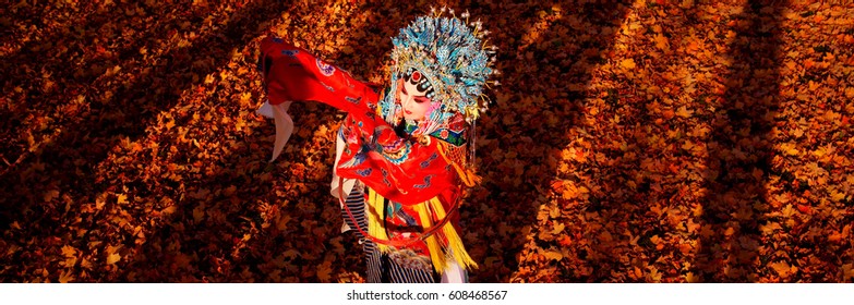 Peking opera performer in the fall outdoor park, Toronto, Canada