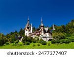 The Peles castle in the town of Sinaia, Transylvania, Carpathian Mountains, Romania, Summer time, bright sunny day with dark blue sky. The Peles castle is one of the most beautiful castles in Europe.