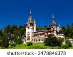 The Peles castle in the town of Sinaia, Transylvania, Carpathian Mountains, Romania, Summer time, bright sunny day with dark blue sky. The Peles castle is one of the most beautiful castles in Europe.