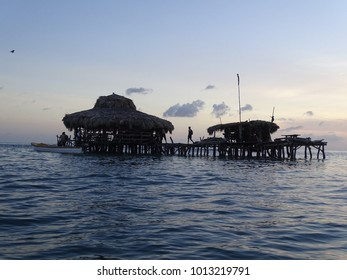 Pelican Bar Jamaica In The Sea During A Beautiful Pink Gold Sunset.