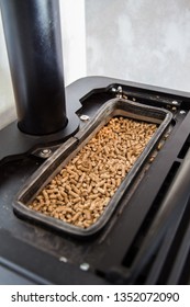Pelletes reservoir of a modern sustainable domestic pellet stove. Burining pellets is very sustainable and effective.