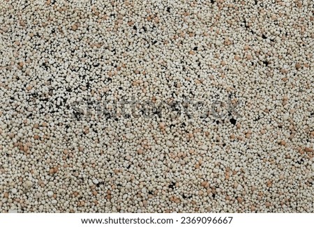 Pellets of ammonium nitrate flat lay with. Mineral fertilizer. granular mineral fertilizer, closeup top view. with black Mineral plant food dressing