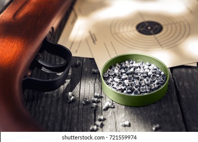 Pellets,air Rifle And Shooting Target On Wooden Table