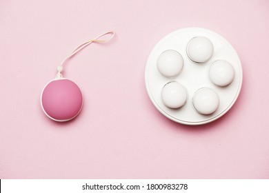 Pelvic Floor Weight And Ball On A Pink Background. Flat Lay. Flat Design. Feminine Intimate Care Concept