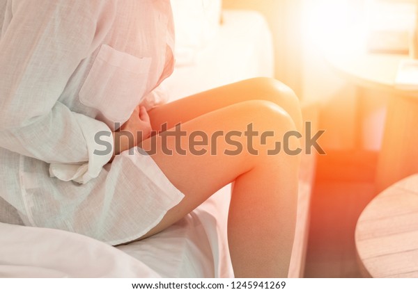 Pelvic pain stomachache medical healthcare concept.\
Hands of young woman on stomach as suffer from menstruation cramp,\
indigestion, gastrointestinal, diarrheas  or female diseases\
problem  