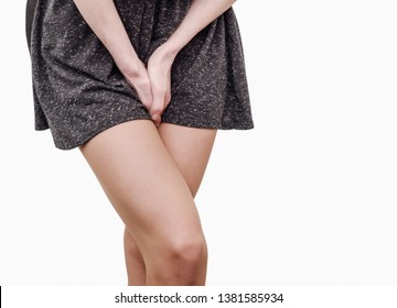 Pelvic thigh young woman with hands holding pressing her crotch of the lower abdomen. Medical or gynecological health problems.